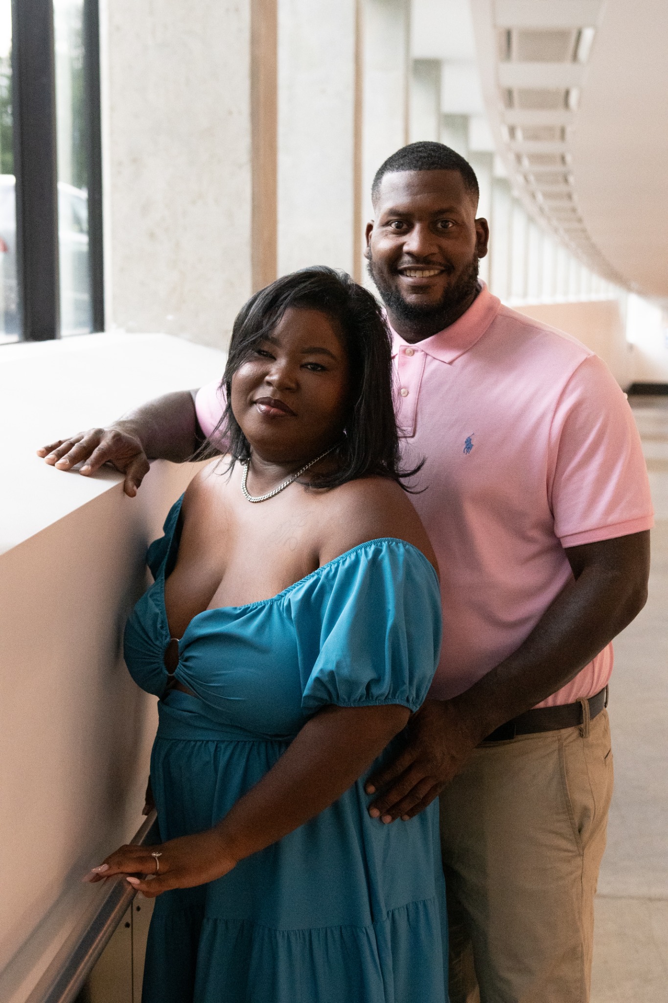 Anita and Brian posing together in a softly lit corridor