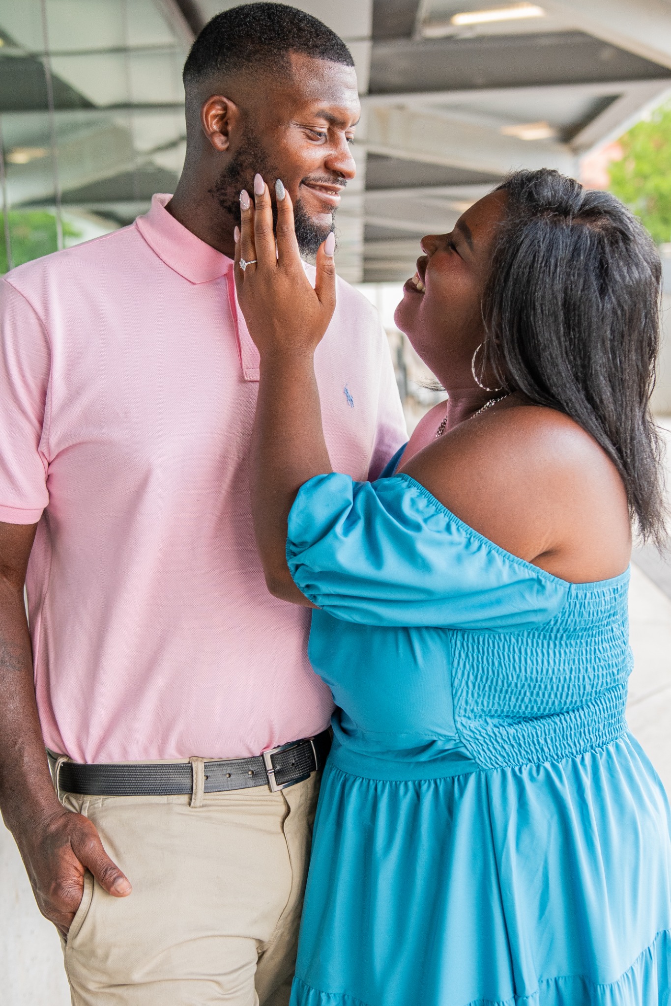 Anita smiling up at Brian while touching his face during their engagement session