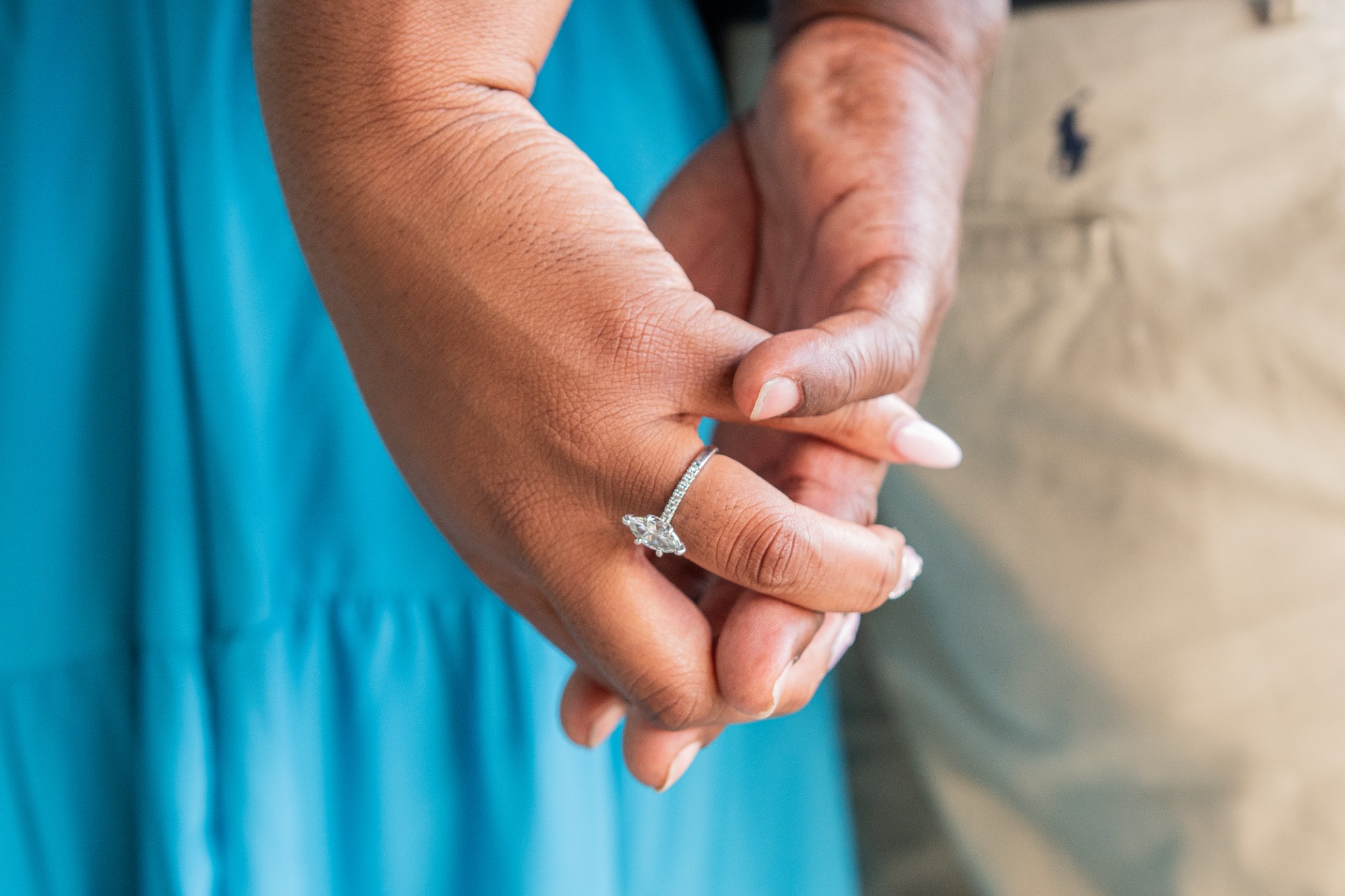 Close-up of Anita and Brian holding hands, featuring Anita’s engagement ring